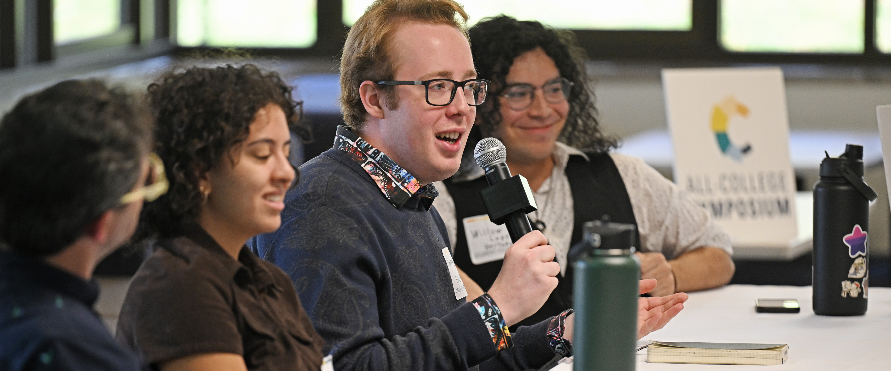 Students participate in a panel at the All-College Symposium