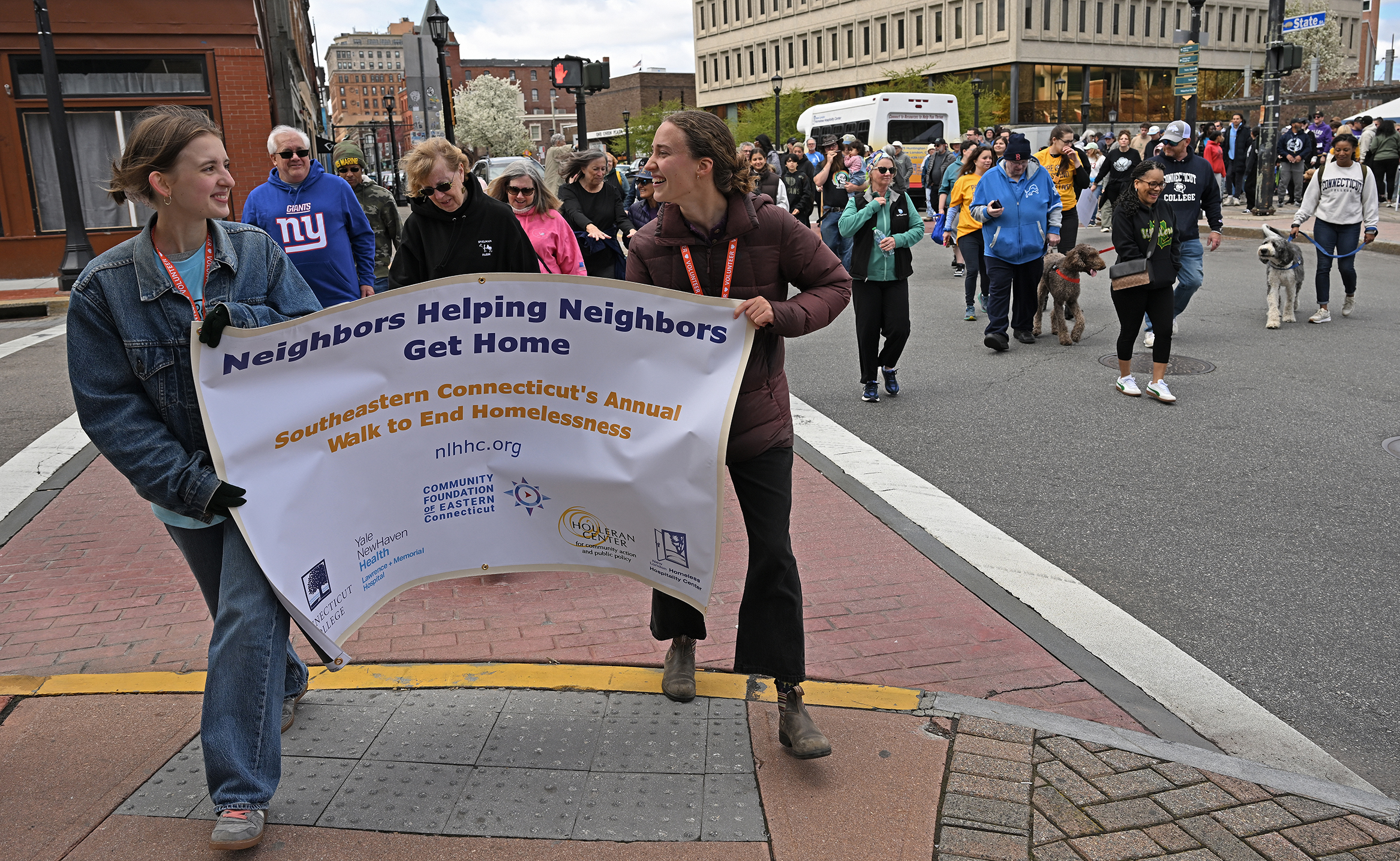 Two female college students carry a banner reading 