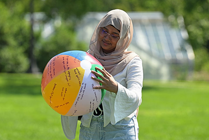 A new student reads questions written on a beach ball.