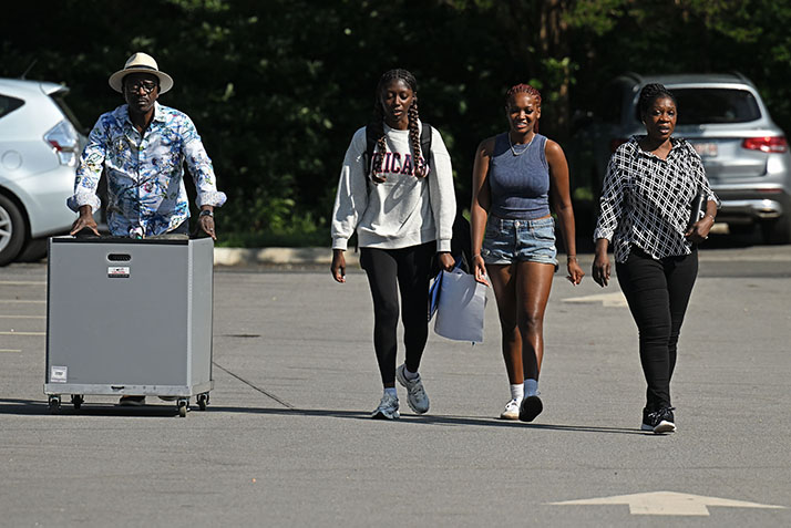 A family moves belongings across campus.