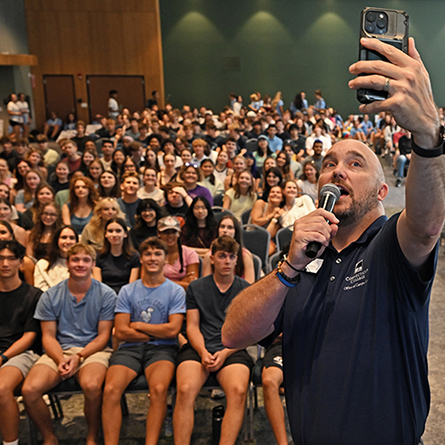 A dean takes a selfie with the Class of 2030.