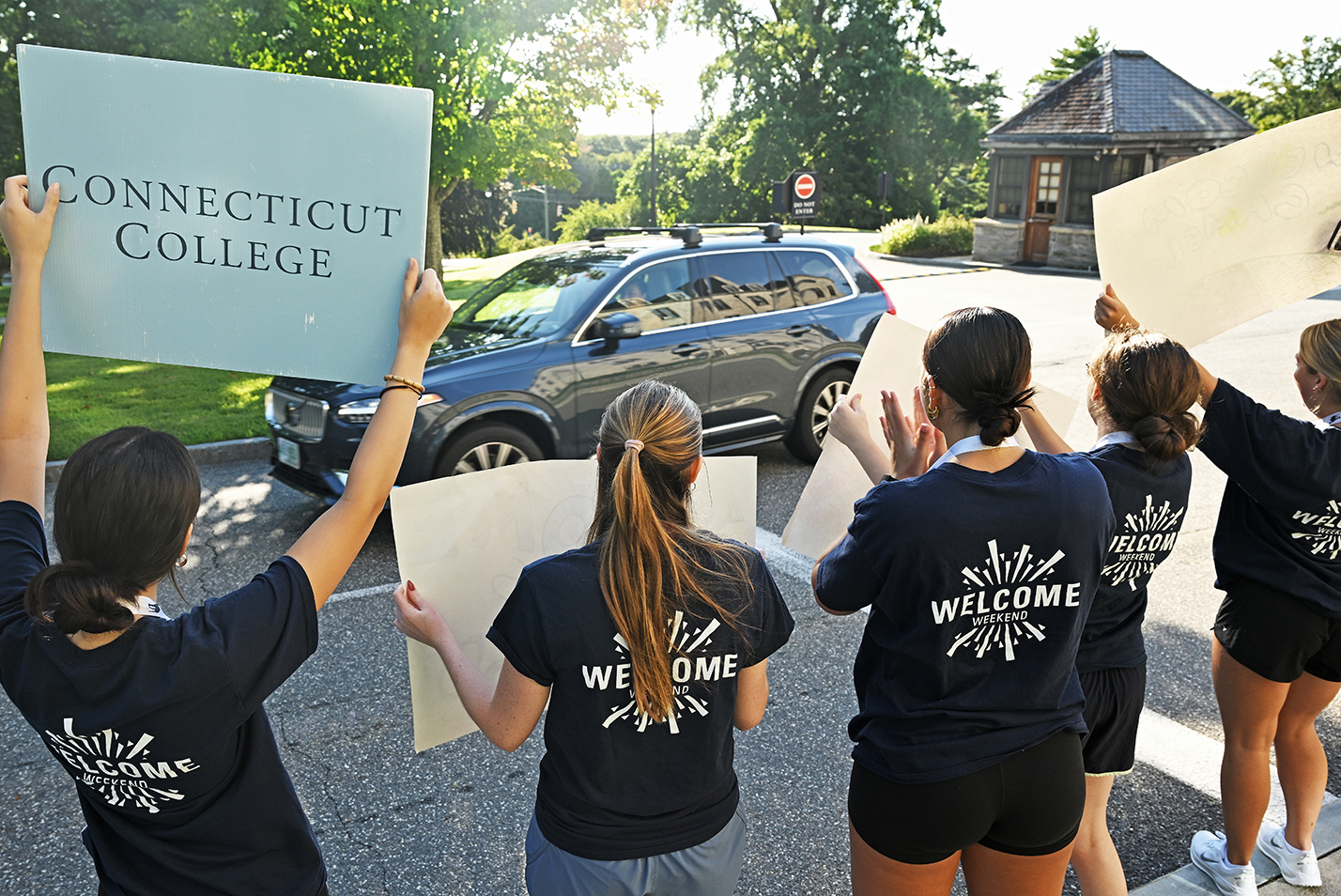 College students in blue t-shirts reading 