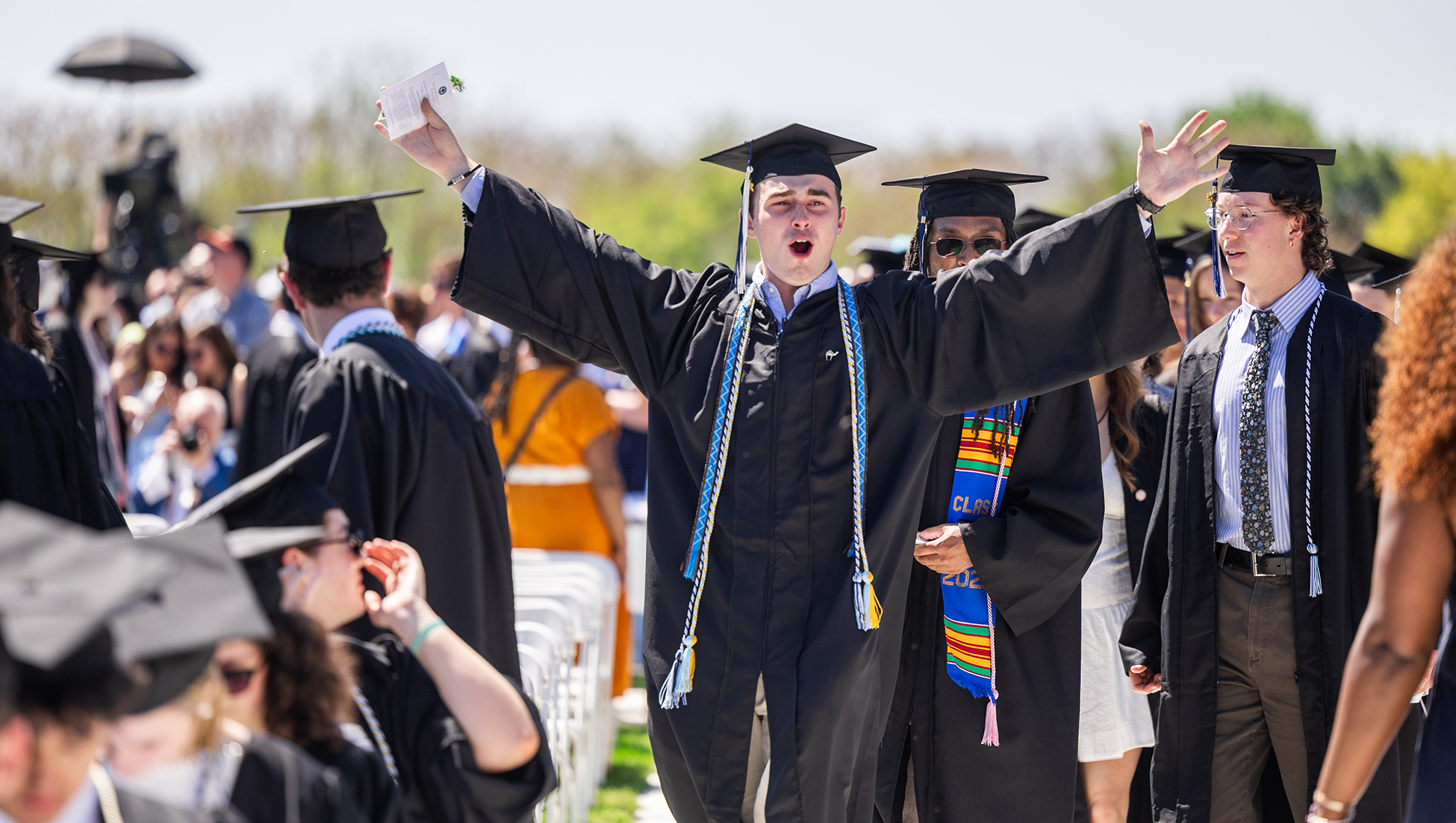 A graduate celebrates during the ceremony.