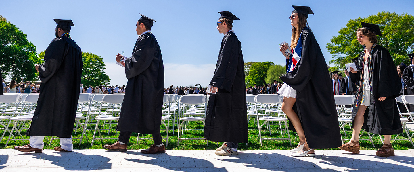 Graduates cross the stage during Commencement.