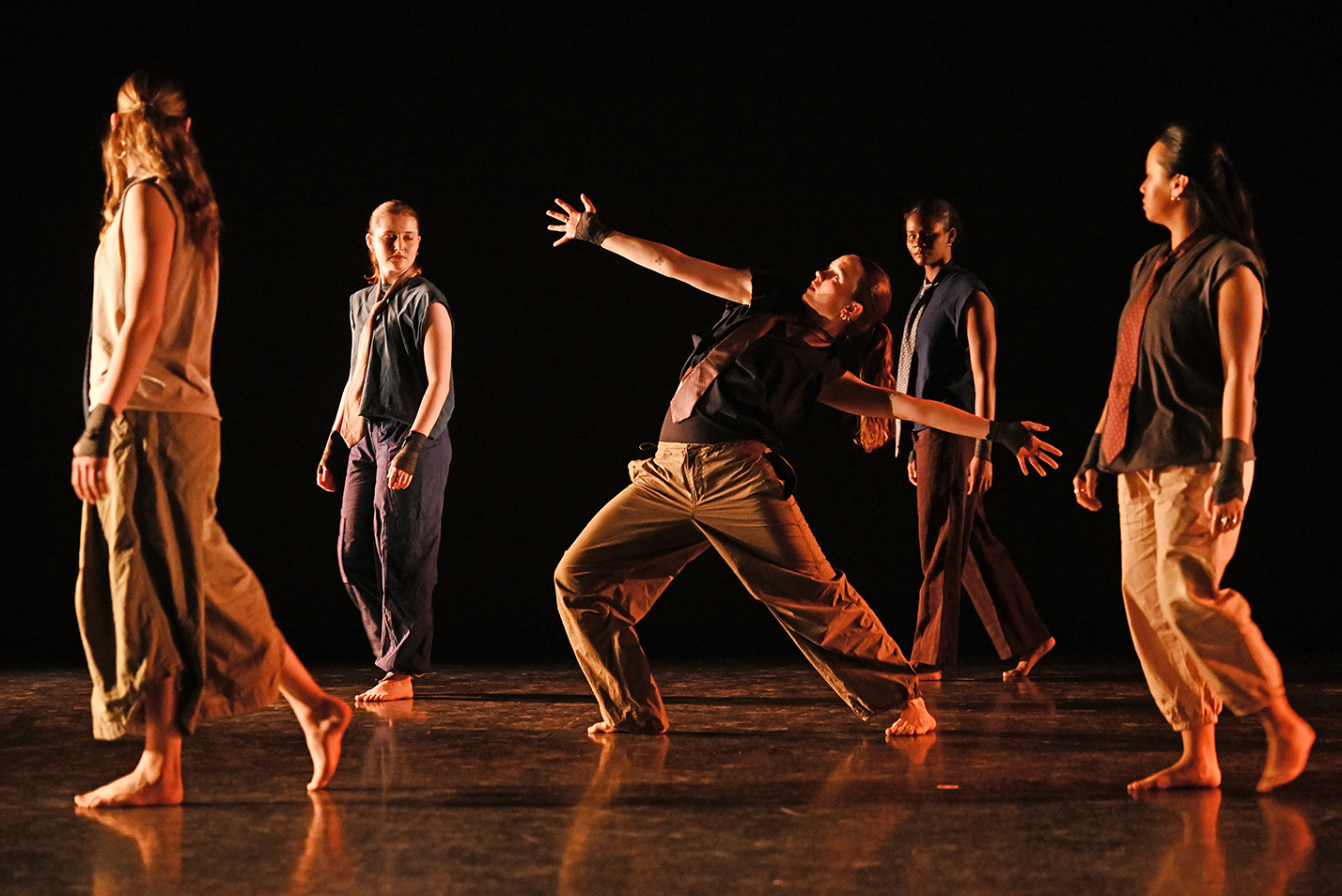 Student dancers perform modern dance in a dance studio.