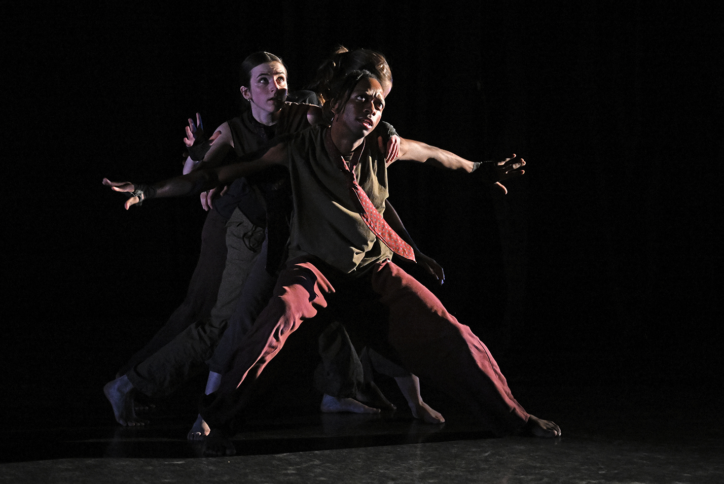 Student dancers perform modern dance in a dance studio.