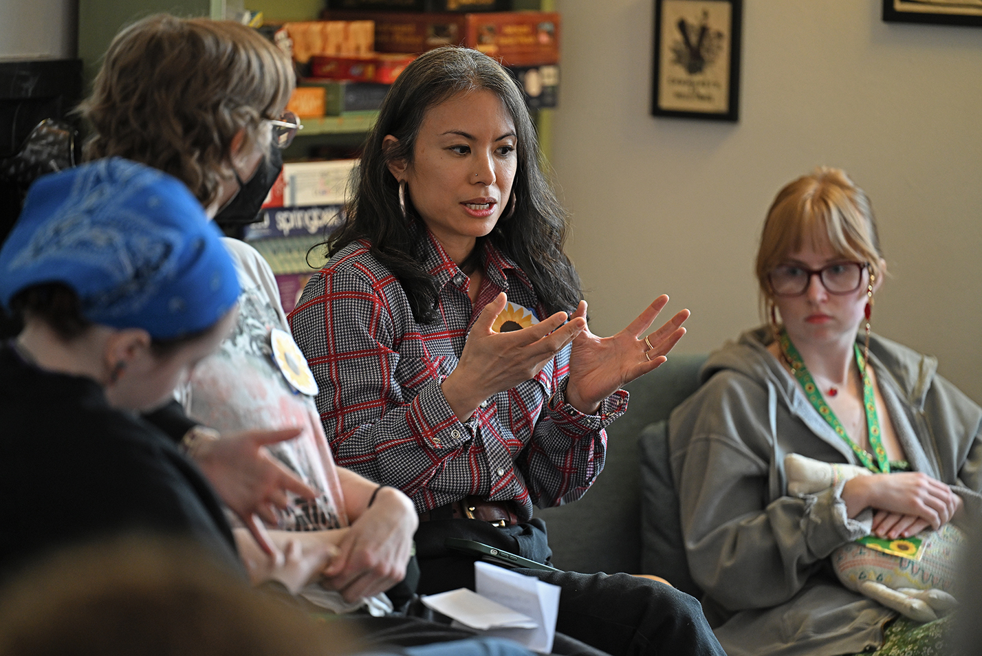 A college professor gestures as she speaks to a group of students.