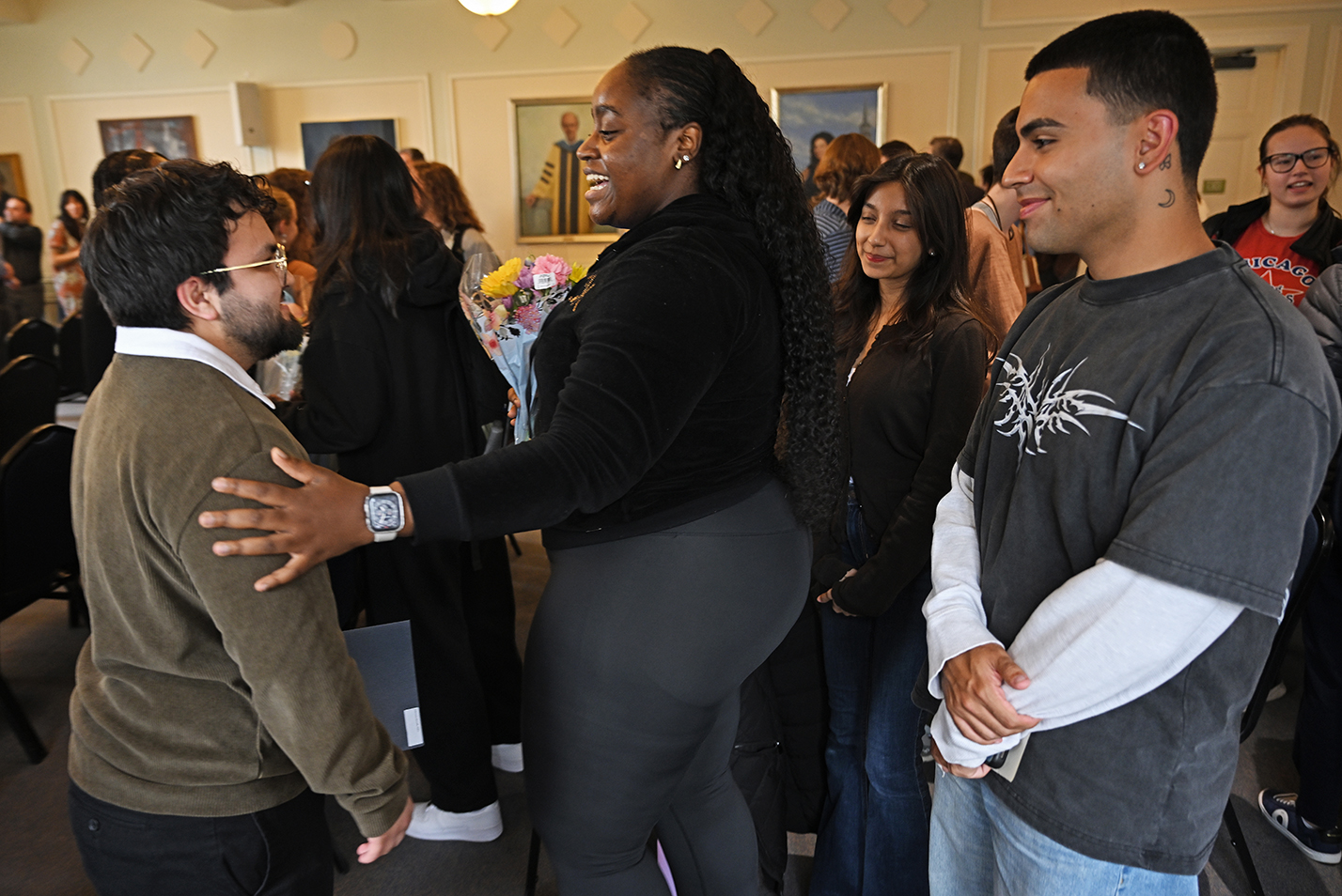 Students congratulate a classmate on induction into an honor society.