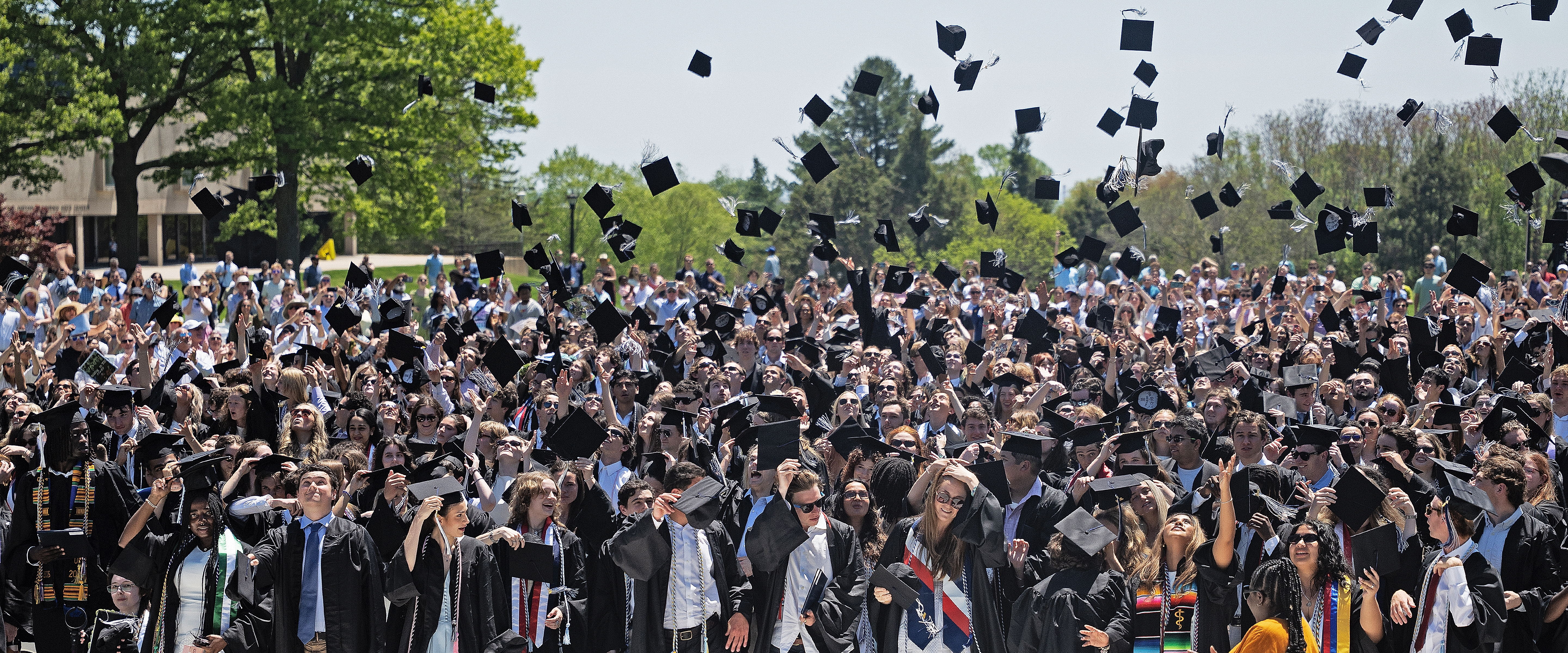 Graduates toss their caps in the air at the conclusion of commencement exercises.