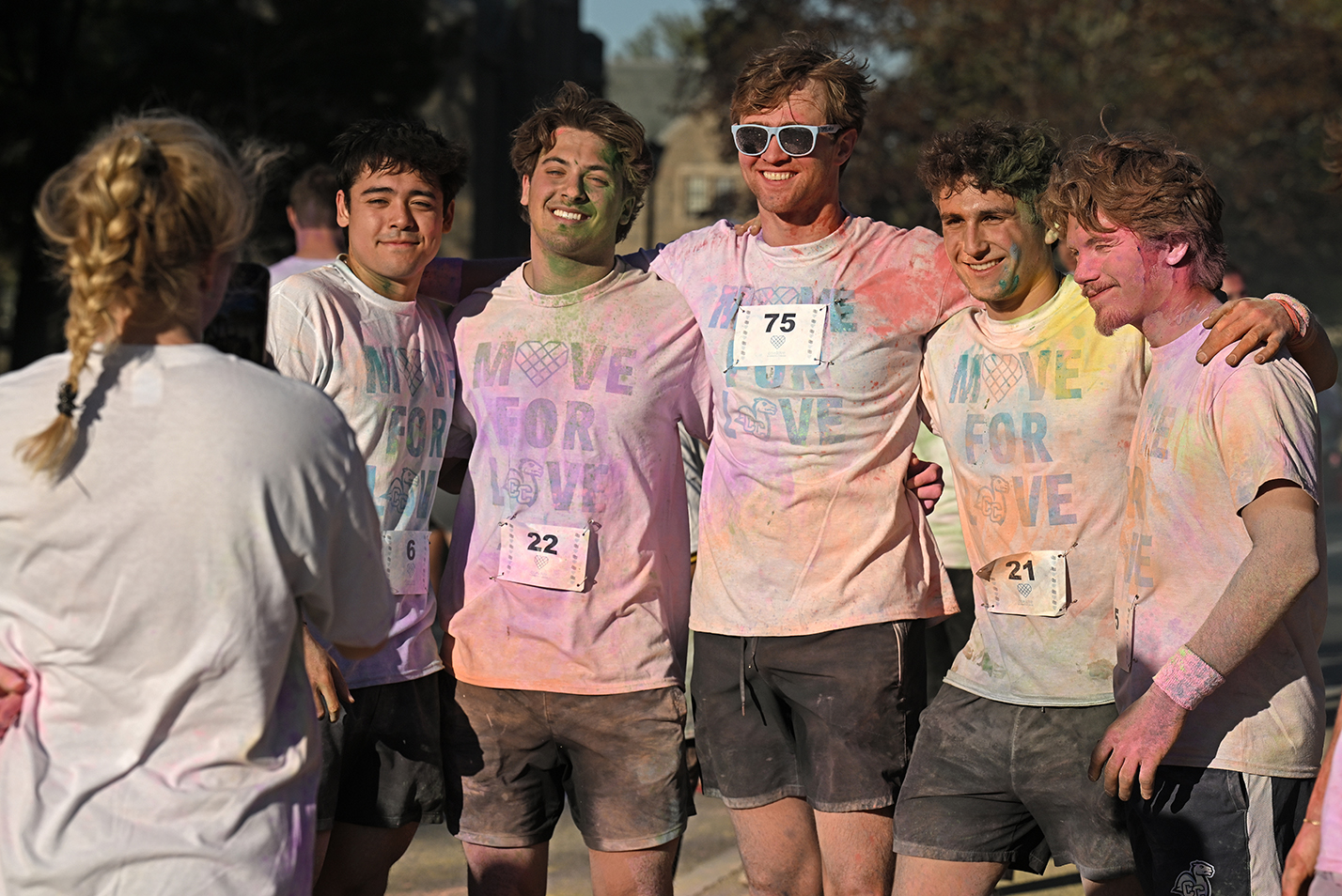 A group of college students in white t-shirts reading 