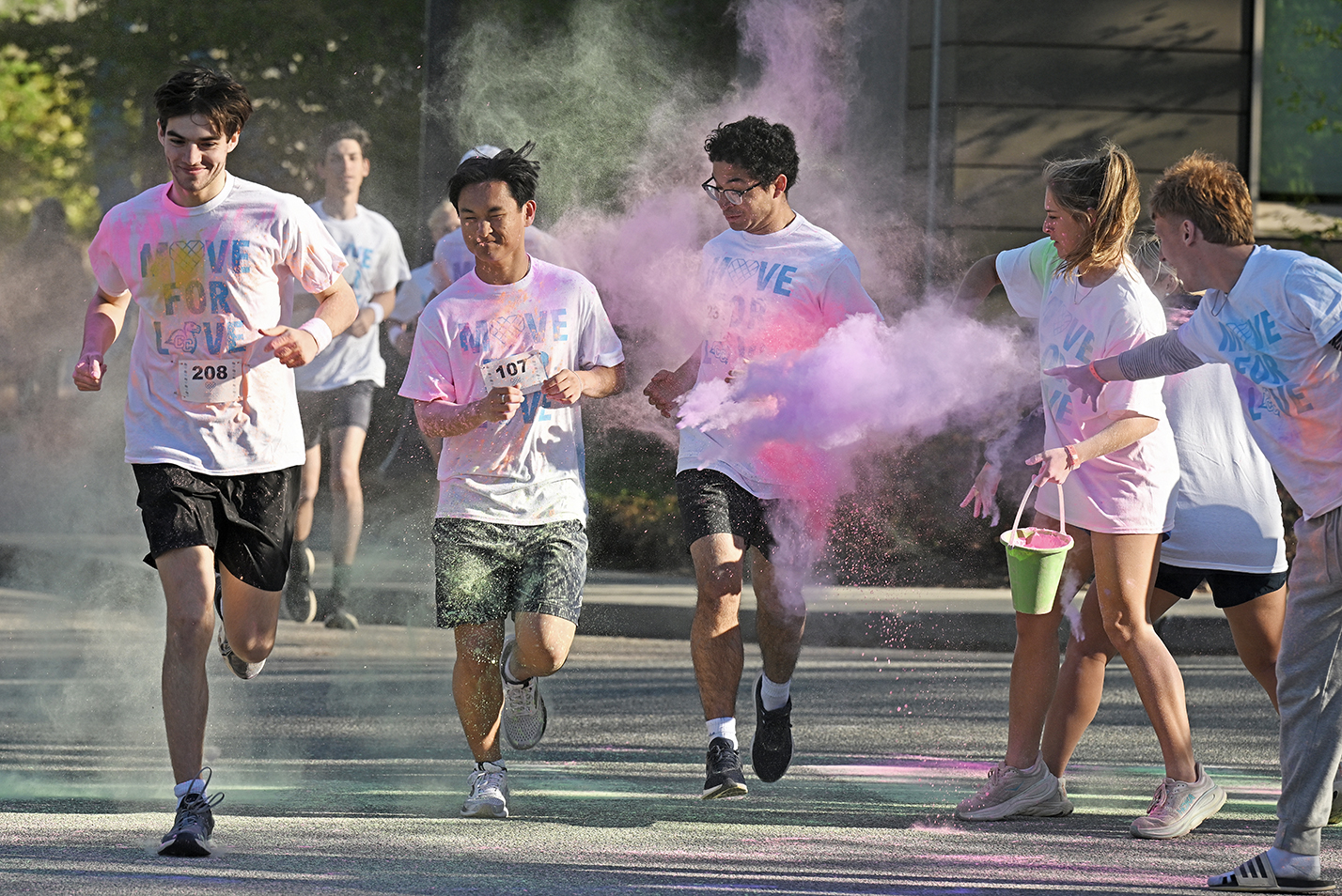 College students in white t-shirts reading 