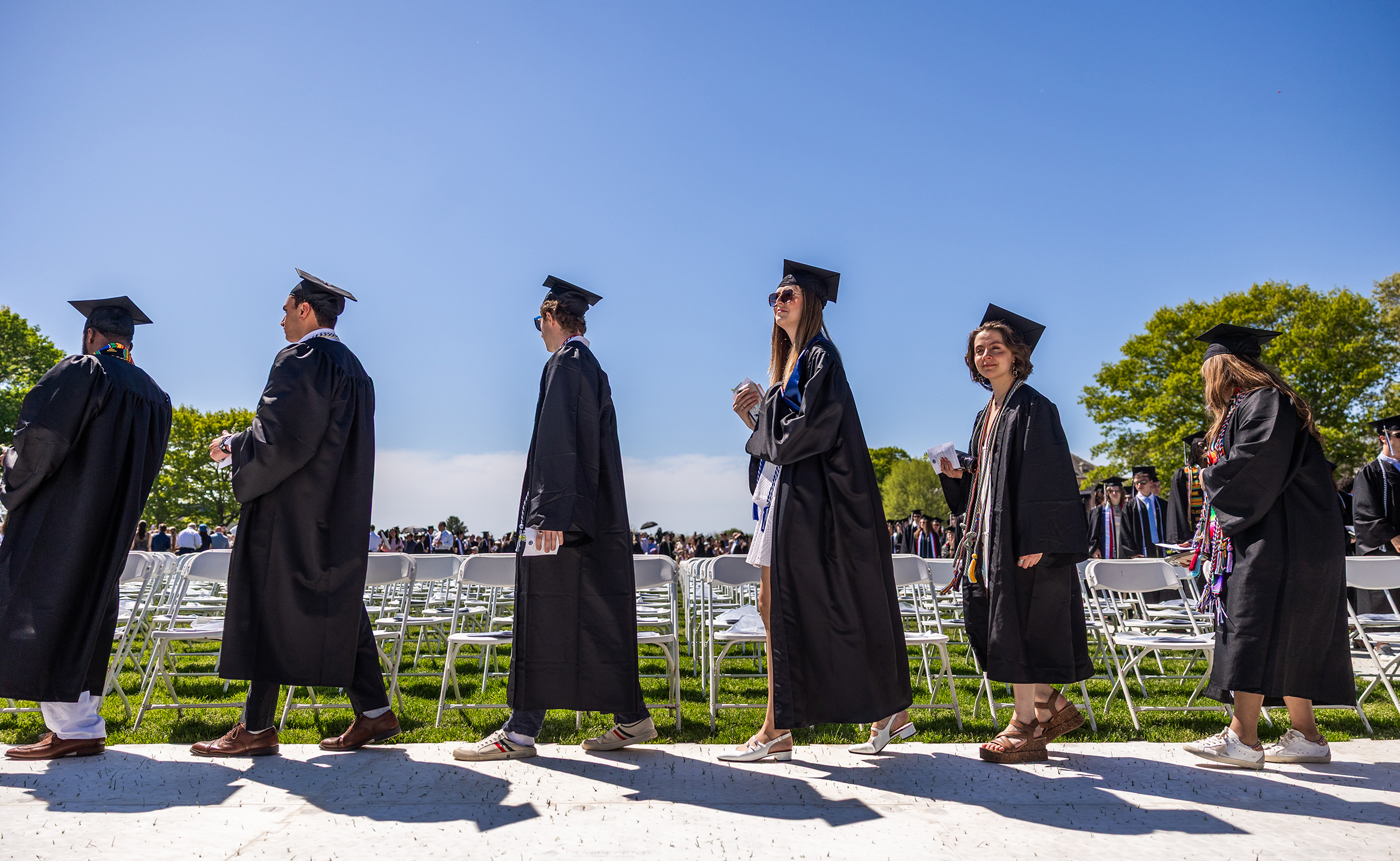 Graduates walk across the stage at Commencement.