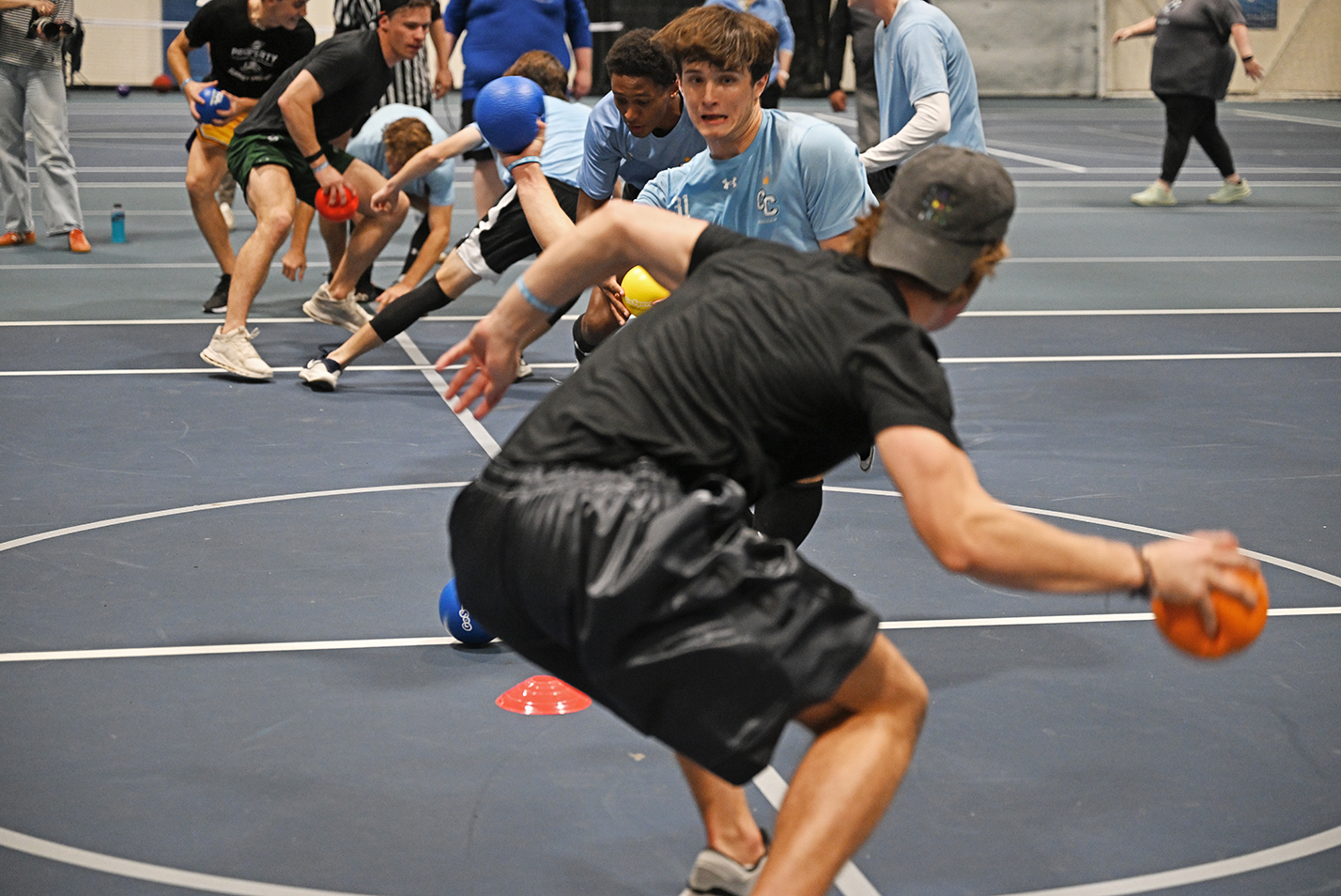 Student athletes square off at point blank range at the start of competition in a dodgeball tournament.