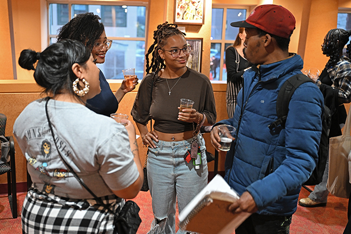 Students attend the We Live Here opening.
