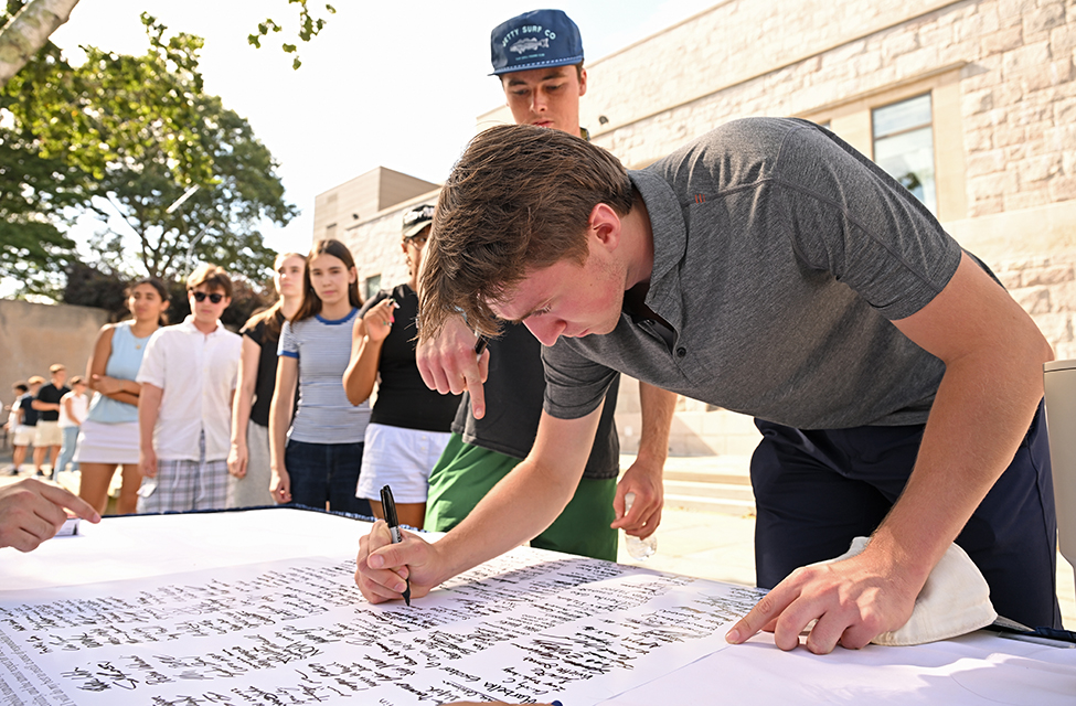 New students sign the Honor Code Pledge.