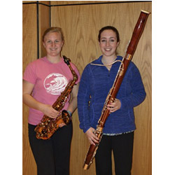 Emily Verschoor-Kirss ’15 (left) and Avery Yurman ’13 pose with their instruments. The two recently participated in the New England Intercollegiate Band Festival at Gordon College.
