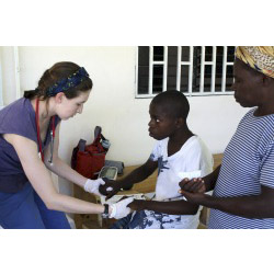 EMT Shannon Brady '14 works with a child during her spring break trip to Haiti last year. 