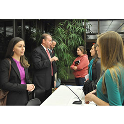 Caitlyn Turgeon '08 (left), human capital consultant at Deloitte Federal Consulting, spoke with students after a panel discussion during the recent 