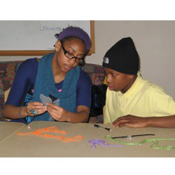 Marline Johnson '13 and a student work on an art project as part of ENRICH, the College's new extended learning time program for students at New London's Bennie Dover Jackson Middle School.
