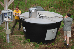 Students turn one of the College's two commercial-sized composting units.