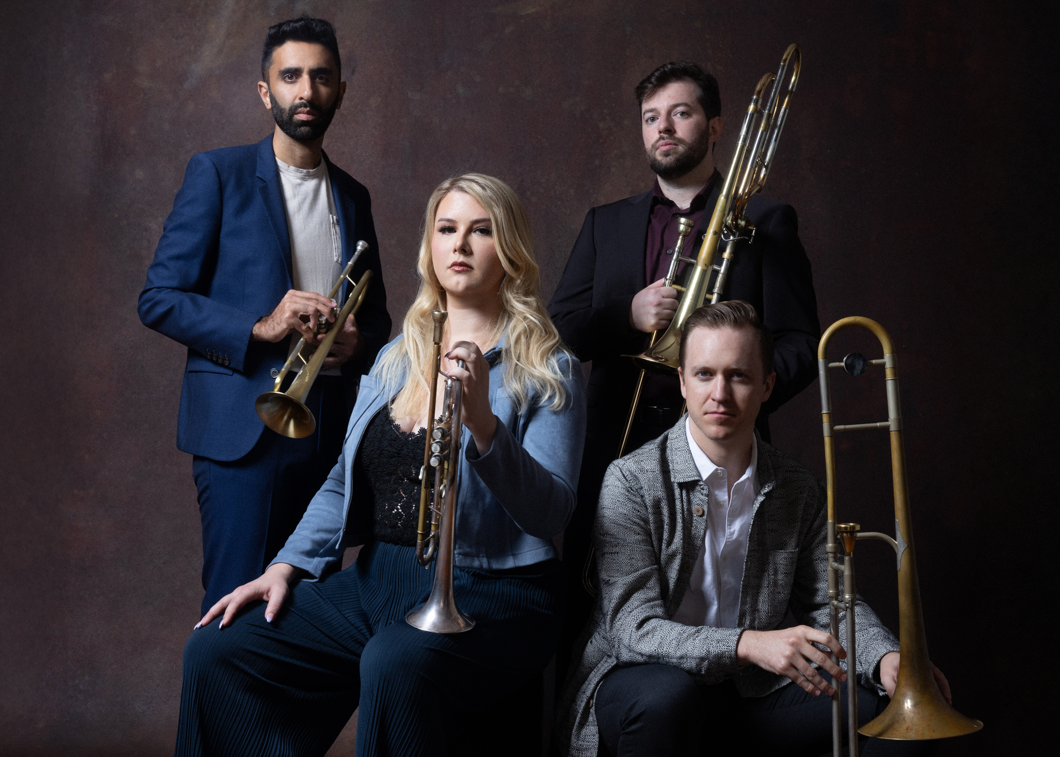 photo of the four musicians holding their wind instruments
