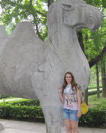 Katie Grossweiner ´12 poses next to the College´s mascot, the camel, while she explores China´s sites.