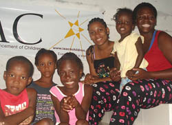 Burrell, right, and Beaubrun, third from right, helped care for children who were orphaned in the January earthquake and taught English to children and adults in Les Cayes.