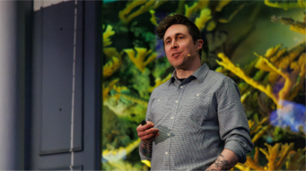 Christopher standing in front of foliage
